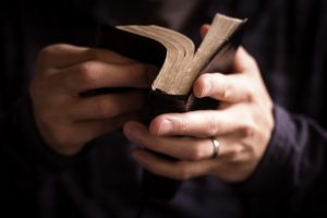 Man opening Bible